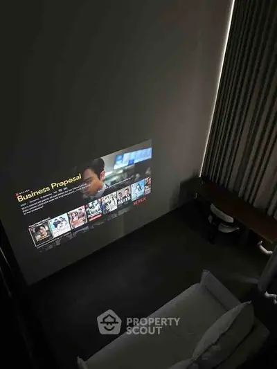 Modern living room with projector screen and cozy seating area