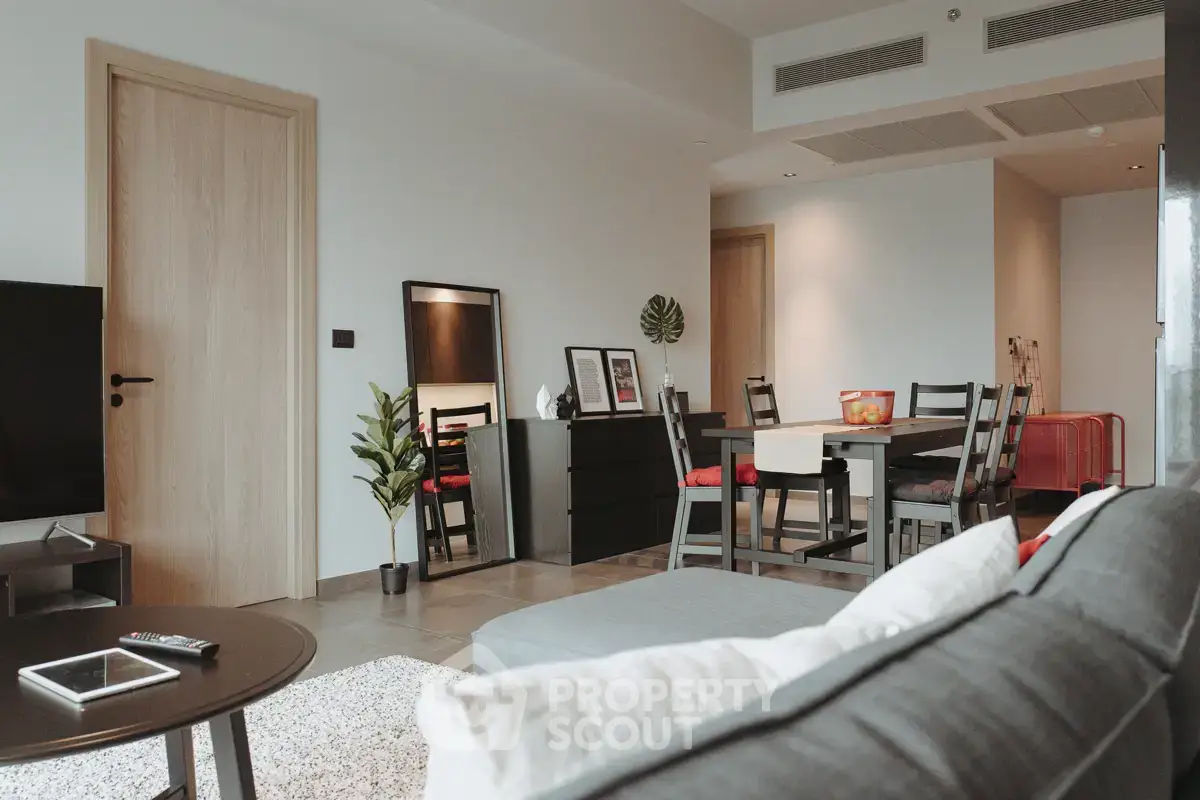 Modern living room with dining area, stylish furniture, and cozy ambiance in a contemporary apartment.