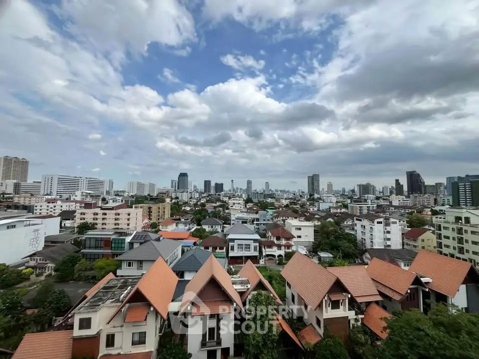 Stunning cityscape view from a high vantage point showcasing urban skyline and residential rooftops.