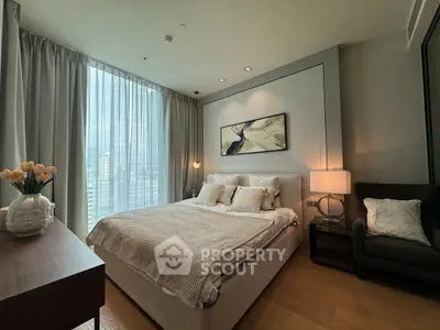 Luxurious bedroom with modern decor and city view, featuring elegant furnishings and ambient lighting.