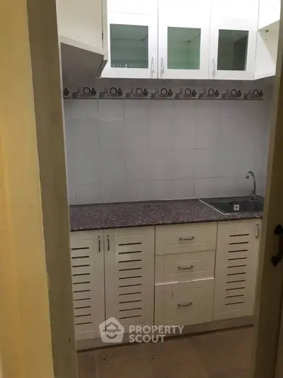 Compact kitchen with closed layout and modern cabinetry