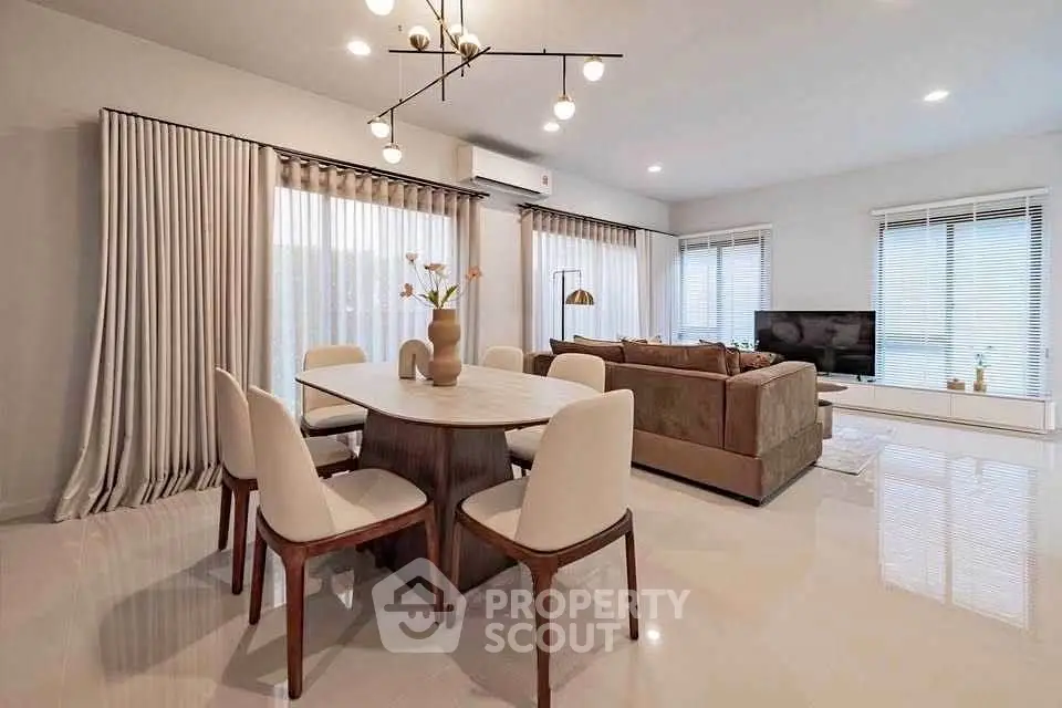 Elegant open-plan living and dining area with modern furnishings and ample natural light.