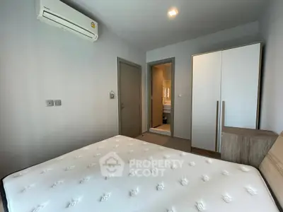 Modern bedroom with air conditioning and minimalist furniture in a cozy apartment.