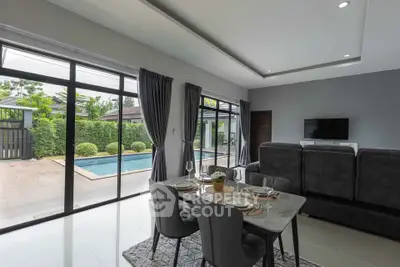 Modern living room with pool view and elegant dining setup