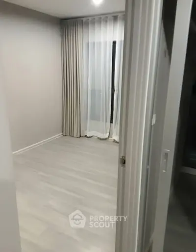 Minimalist empty room with elegant curtains and wooden flooring