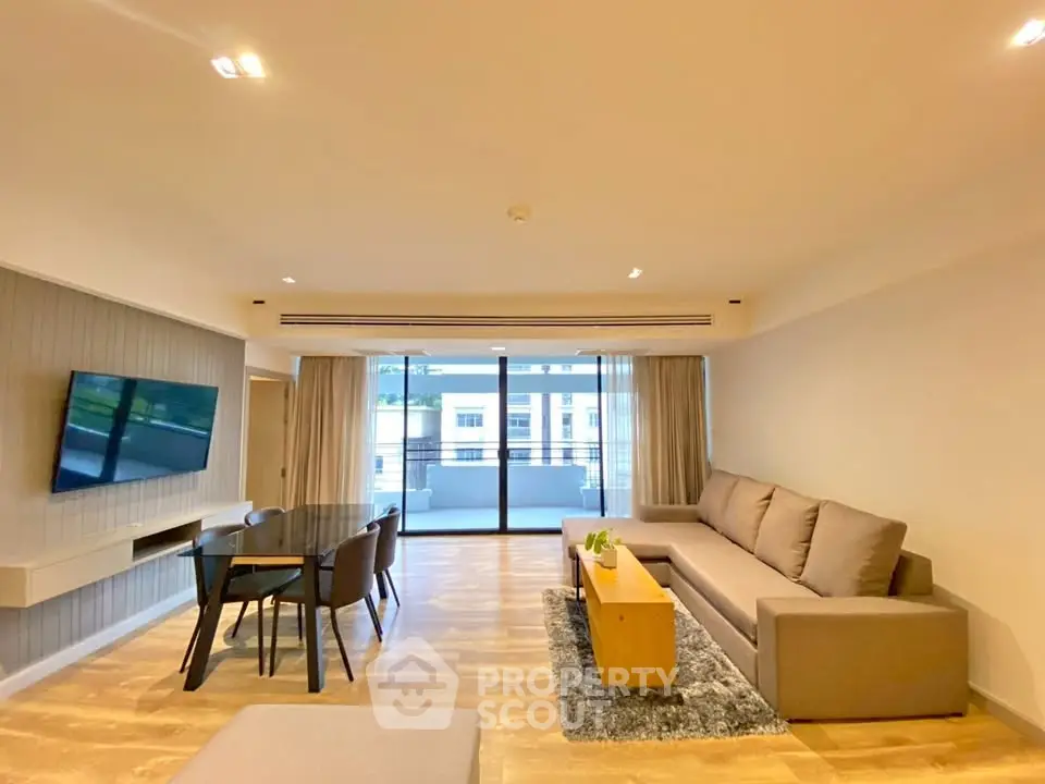 Spacious modern living room with large balcony and stylish furnishings