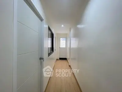 Bright and spacious hallway with wooden flooring and modern design