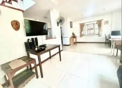 Spacious living room with modern decor and open layout, perfect for family gatherings.