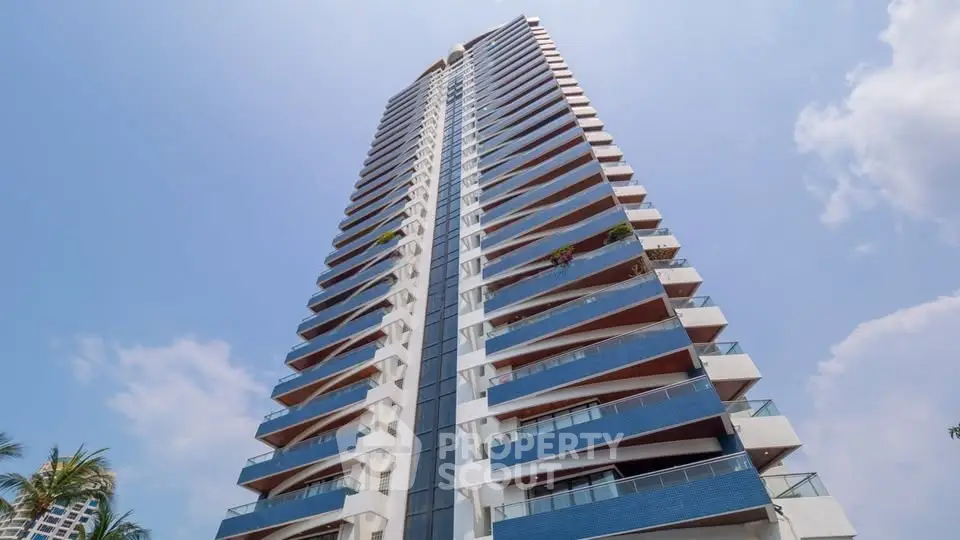Stunning high-rise building with modern architecture and blue accents against a clear sky.
