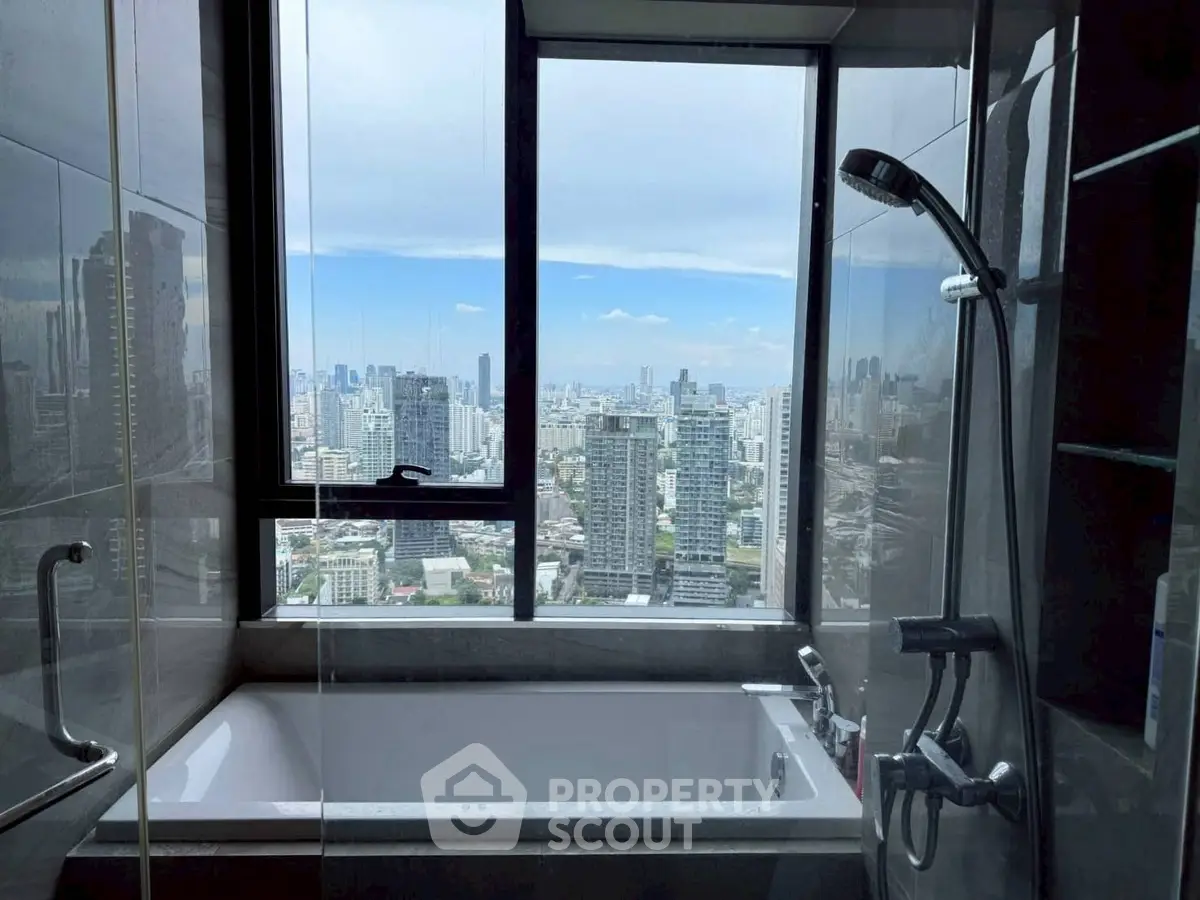 Luxurious bathroom with stunning city view from large window