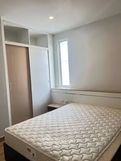 Cozy bedroom with natural light and built-in closet, perfect for restful nights.