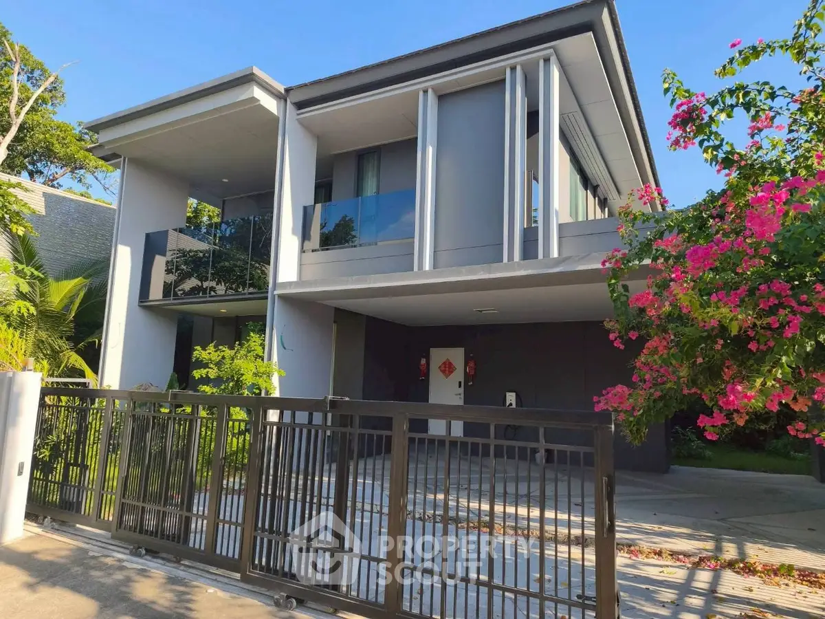 Modern two-story house with sleek design and lush garden