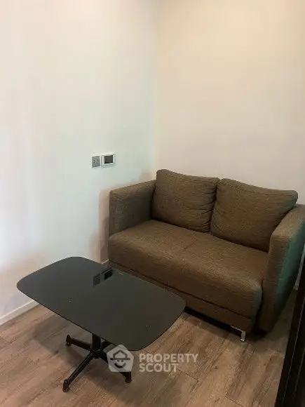 Cozy small living room with a compact sofa and modern coffee table, perfect for urban apartments.