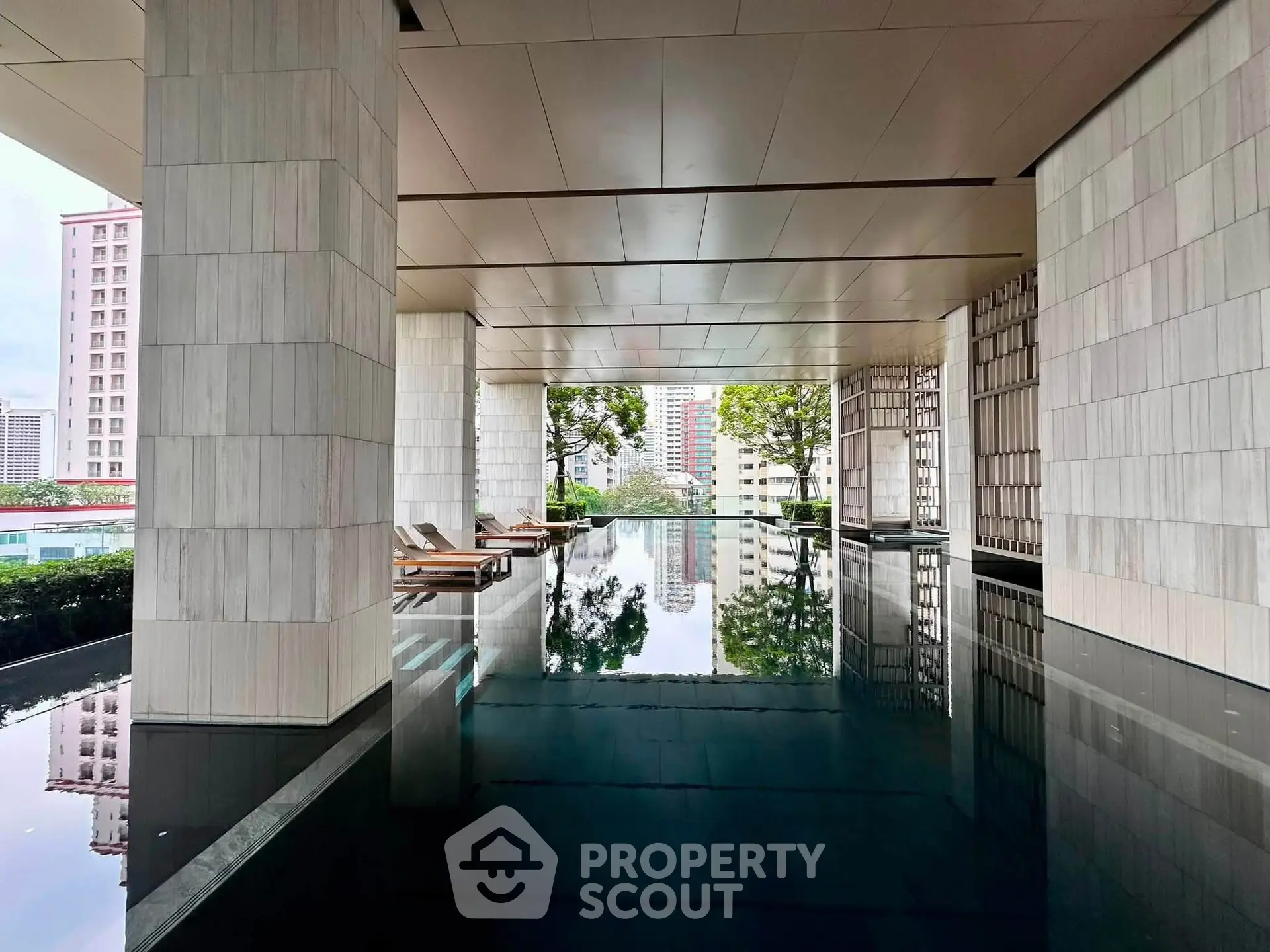 Luxurious modern pool area with sleek design and city views, perfect for relaxation and leisure.