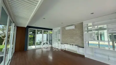 Spacious modern living room with large windows and pool view