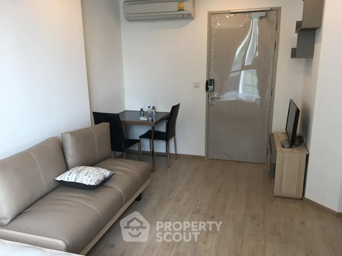 Modern living room with sleek furniture and air conditioning in a cozy apartment.