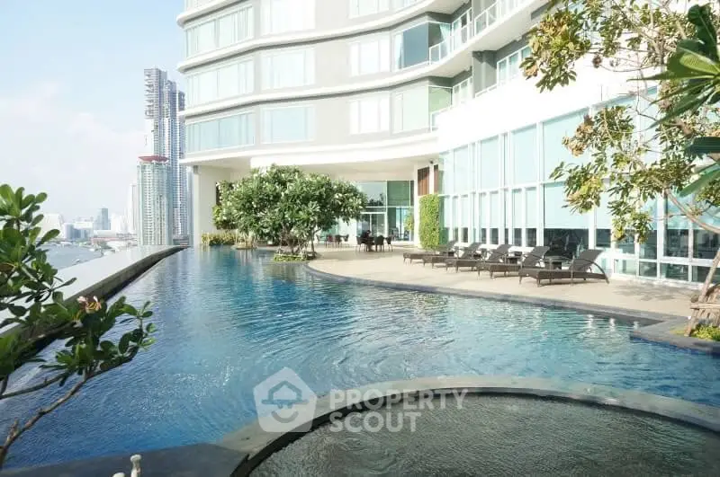 Luxurious high-rise building with stunning infinity pool and city skyline view.