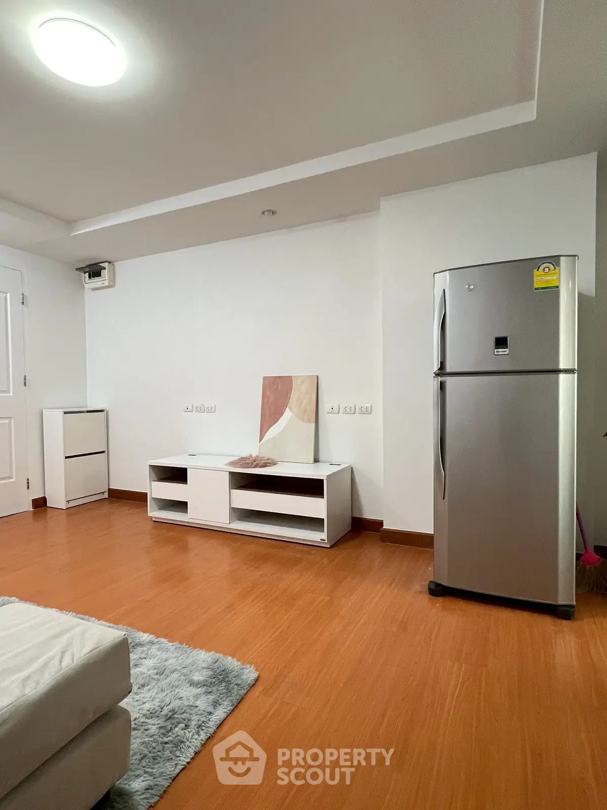 Modern living room with sleek fridge and minimalist decor