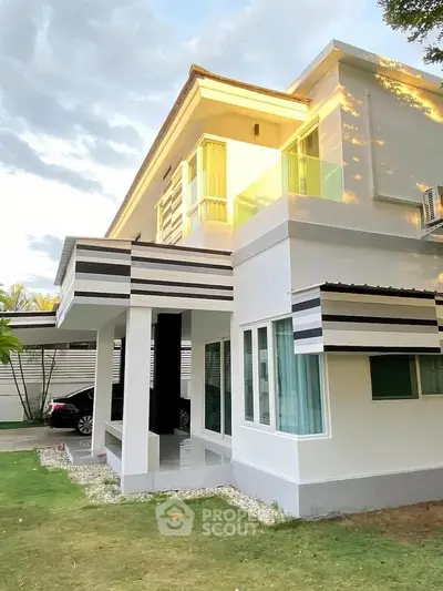 Modern two-story house with sleek design and large windows, perfect for contemporary living.
