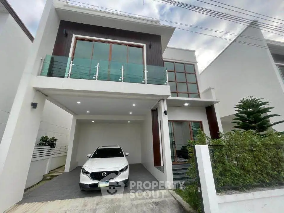 Modern two-story house with sleek design and carport