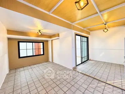 Spacious modern living room with large windows and stylish lighting