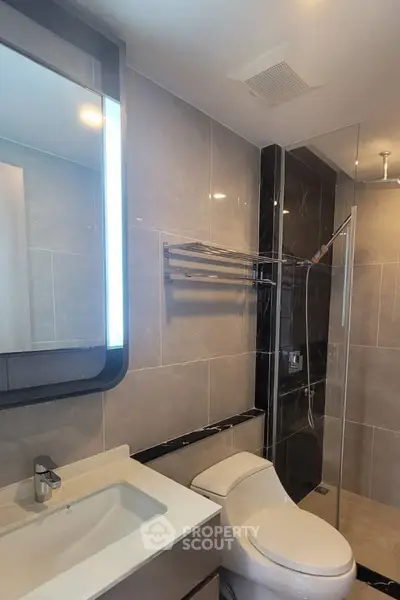 Modern bathroom with sleek fixtures and glass shower enclosure
