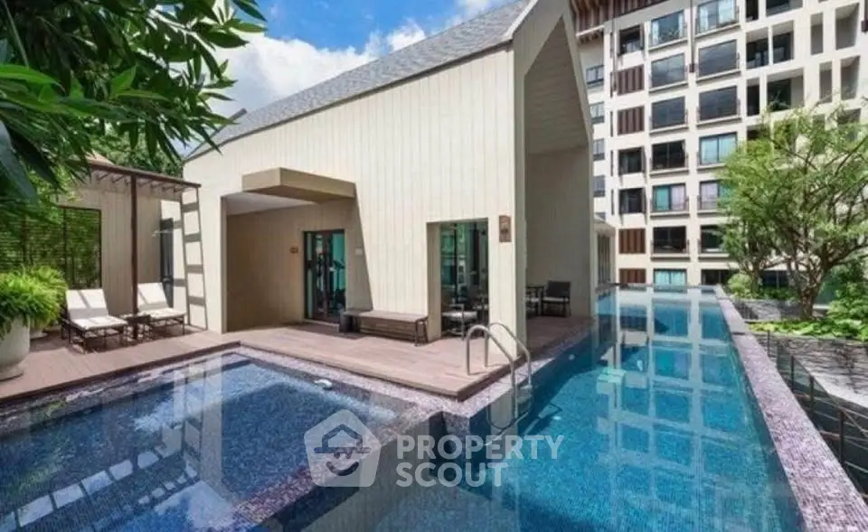 Luxurious modern building with stunning pool and lush greenery, perfect for relaxation and leisure.