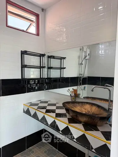 Stylish bathroom with modern sink and geometric tile design