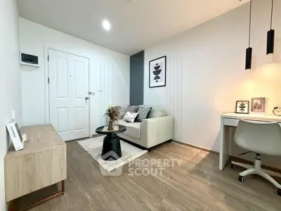 Modern living room with stylish decor and cozy seating area, perfect for relaxation and work-from-home setup.