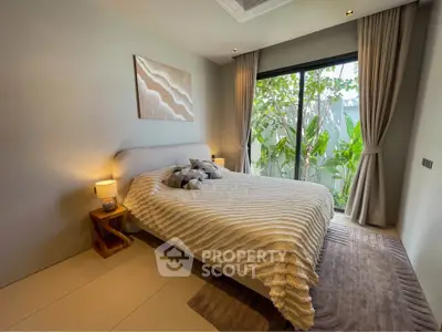 Cozy bedroom with large window and garden view, featuring elegant decor and soft lighting.