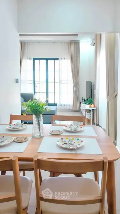 Bright dining area with modern decor and natural light in a stylish apartment.