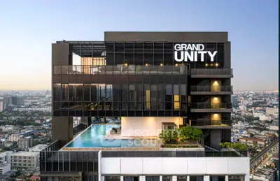 Stunning modern high-rise building with rooftop pool and panoramic city views.