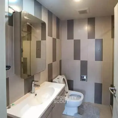 Modern bathroom with stylish tile design and sleek fixtures.