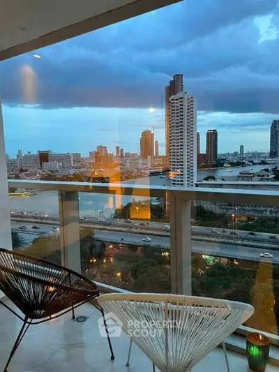 Stunning cityscape view from a modern balcony with stylish seating, perfect for urban living.