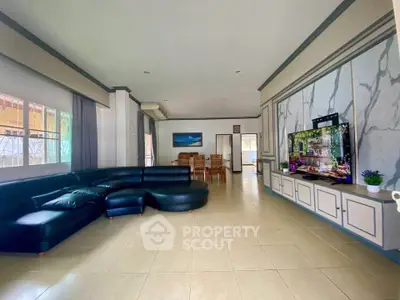 Spacious living room with elegant decor and large sectional sofa, perfect for family gatherings.