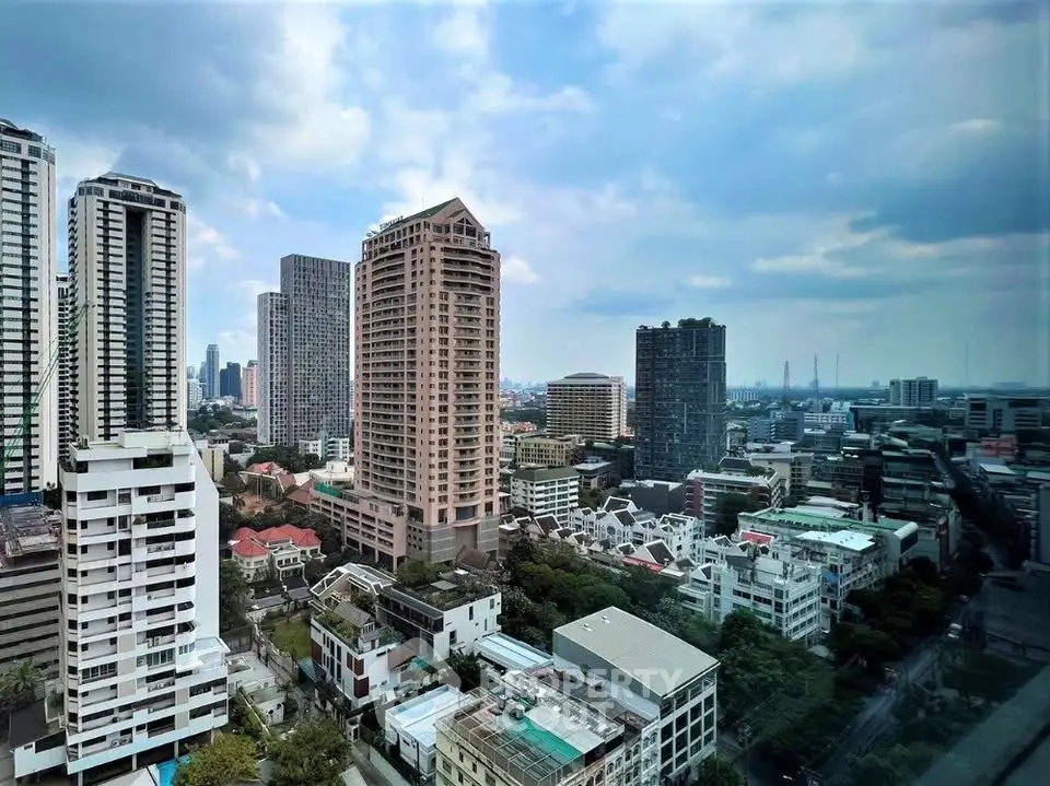 Stunning cityscape view from high-rise building showcasing urban skyline and residential areas.