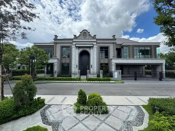Luxurious modern mansion with grand entrance and lush landscaping