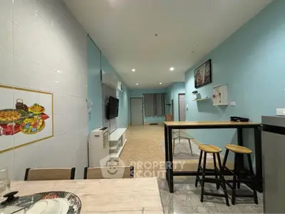 Spacious open-plan living area with modern decor and stylish furniture, perfect for comfortable living.