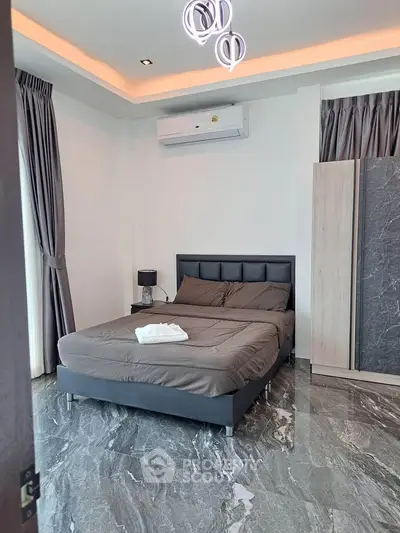 Modern bedroom with sleek design, marble flooring, and ambient lighting for a luxurious feel.