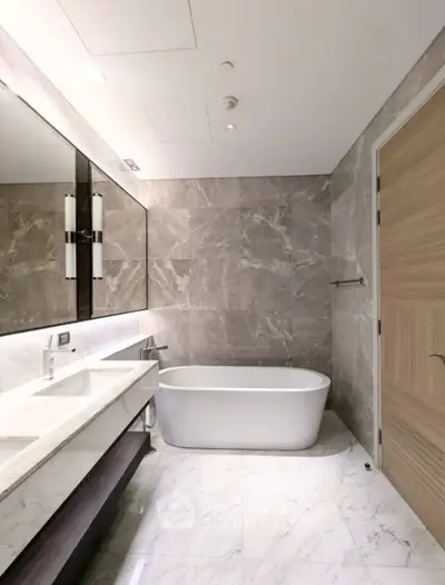 Luxurious modern bathroom with marble finishes and freestanding bathtub