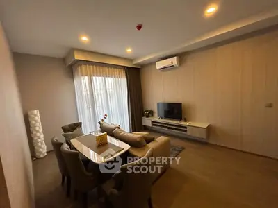 Modern living room with elegant decor, cozy seating, and ambient lighting for a comfortable lifestyle.