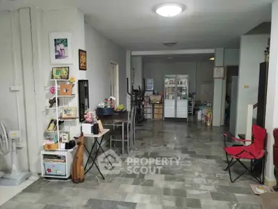 Spacious living area with eclectic decor and tiled flooring, perfect for creative home design.