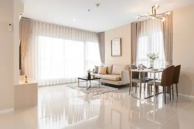 Spacious modern living room with elegant dining area and large windows in a luxury apartment.