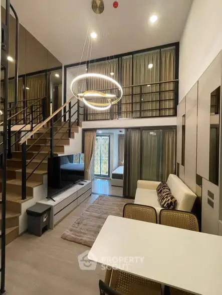 Modern duplex living room with stylish lighting and staircase