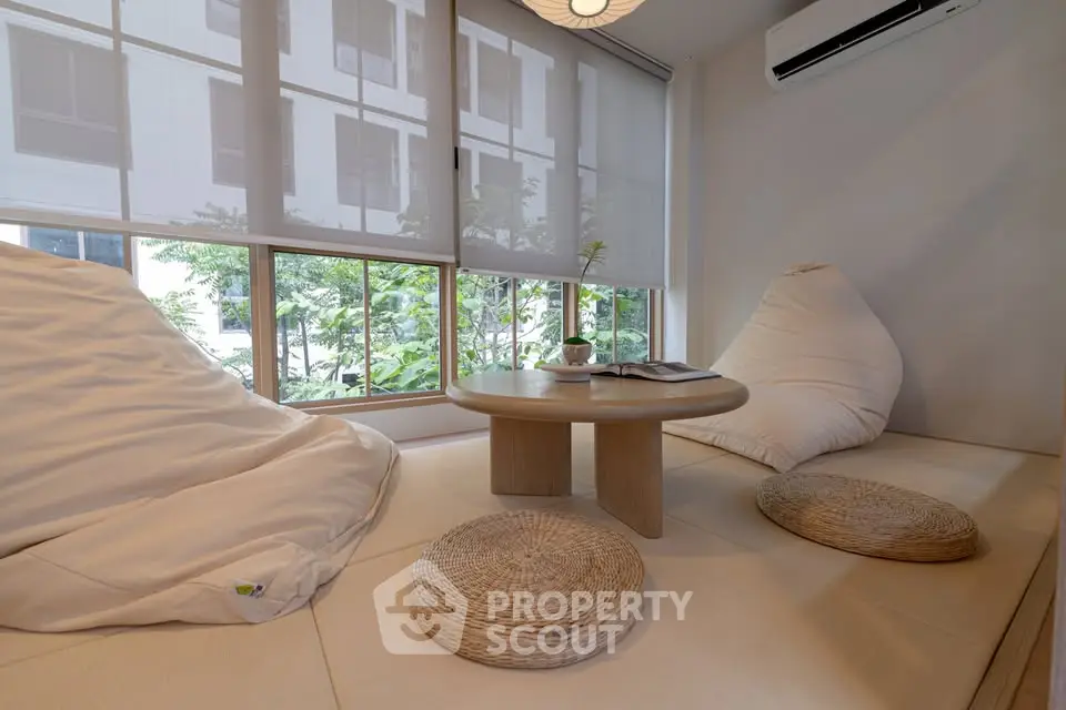 Cozy modern living room with large windows and minimalist decor