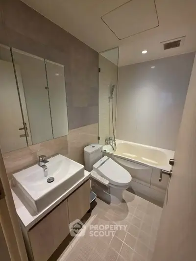 Modern bathroom with sleek fixtures and bathtub in a contemporary apartment.