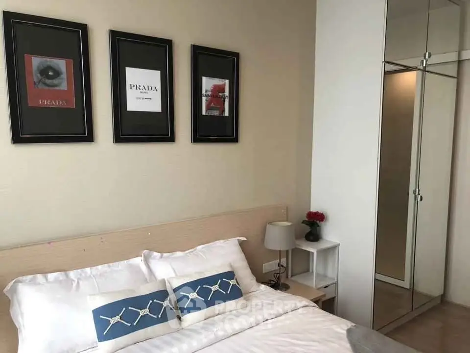 Stylish bedroom with modern decor and mirrored wardrobe in a cozy apartment.