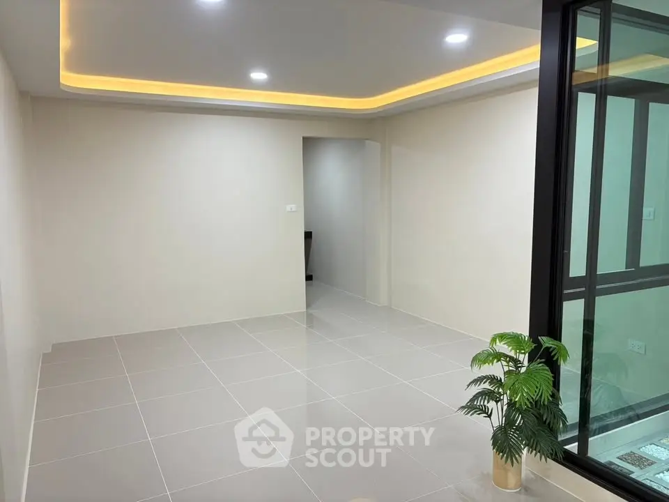 Modern minimalist interior with recessed lighting and tiled flooring, perfect for customization.
