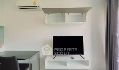 Modern living room with wall-mounted TV and air conditioning unit