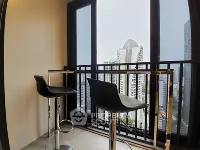 Modern balcony with city view and stylish bar stools in high-rise apartment.